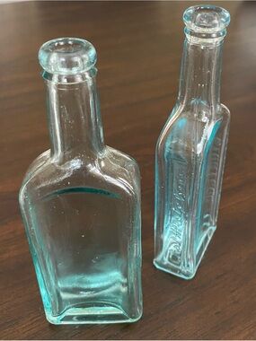 Vintage CASTORIA Embossed Light Blue Glass Medicine Bottles Pair (2)